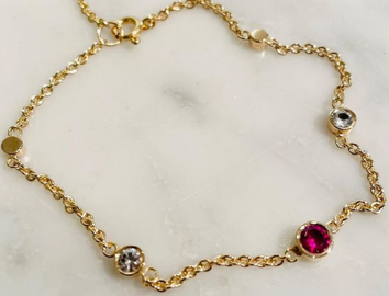 Bracelet in 18k gold with a ruby and white sapphires