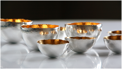 small silver bowls with 24ct gold